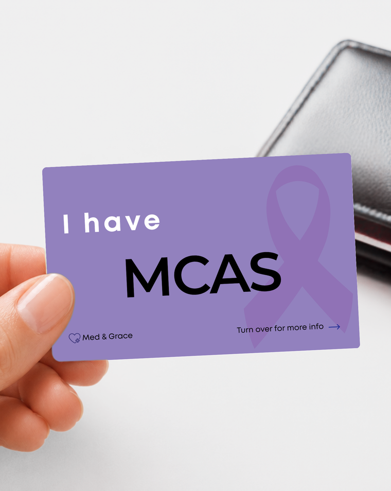 Purple MCAS (Mast Cell Activation Syndrome) medical alert card held in hand