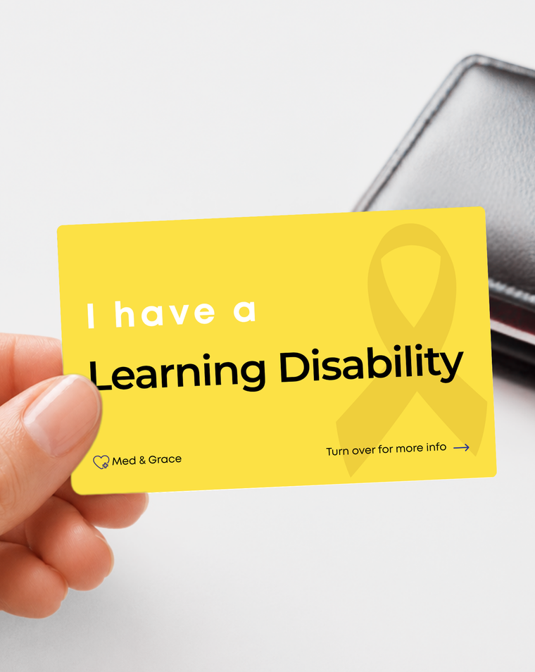 Yellow Learning Disability medical alert card held in hand
