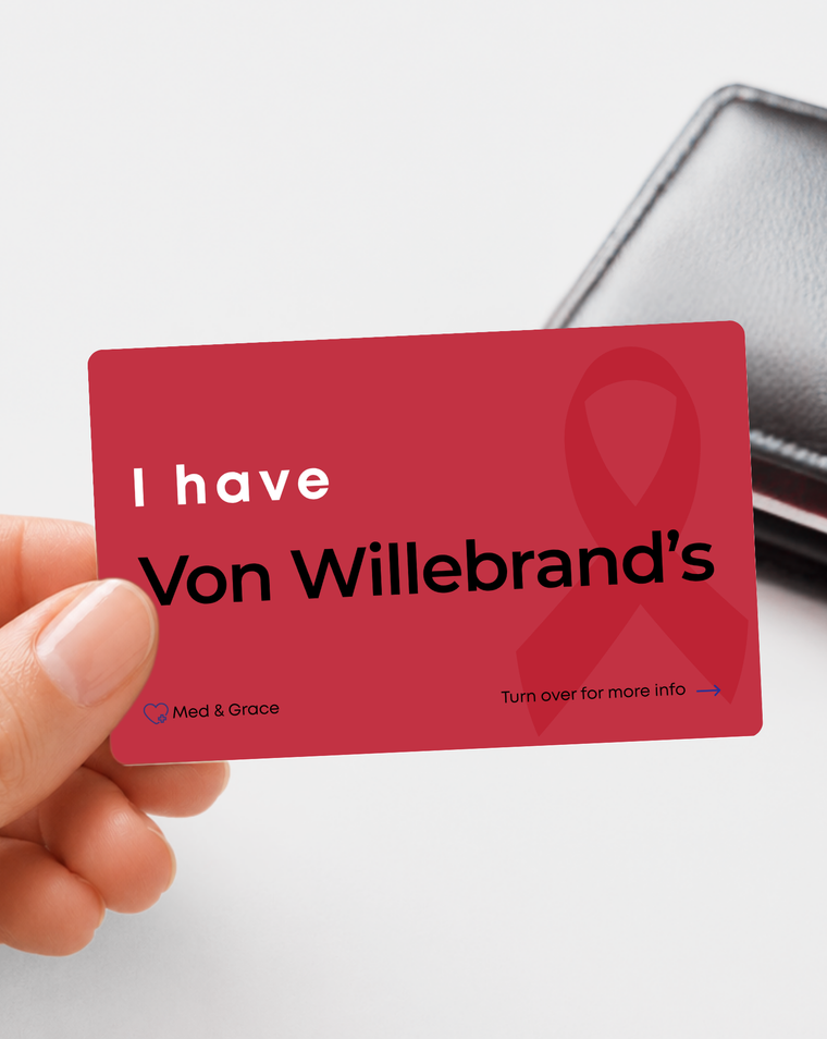 Red Von Willebrand’s medical alert card held in hand