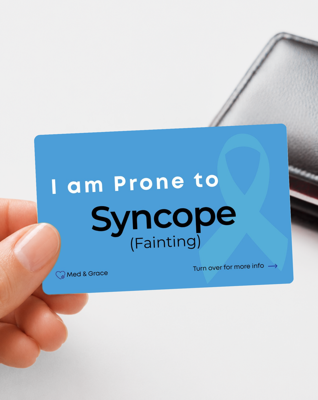 Blue Syncope medical alert card held in hand