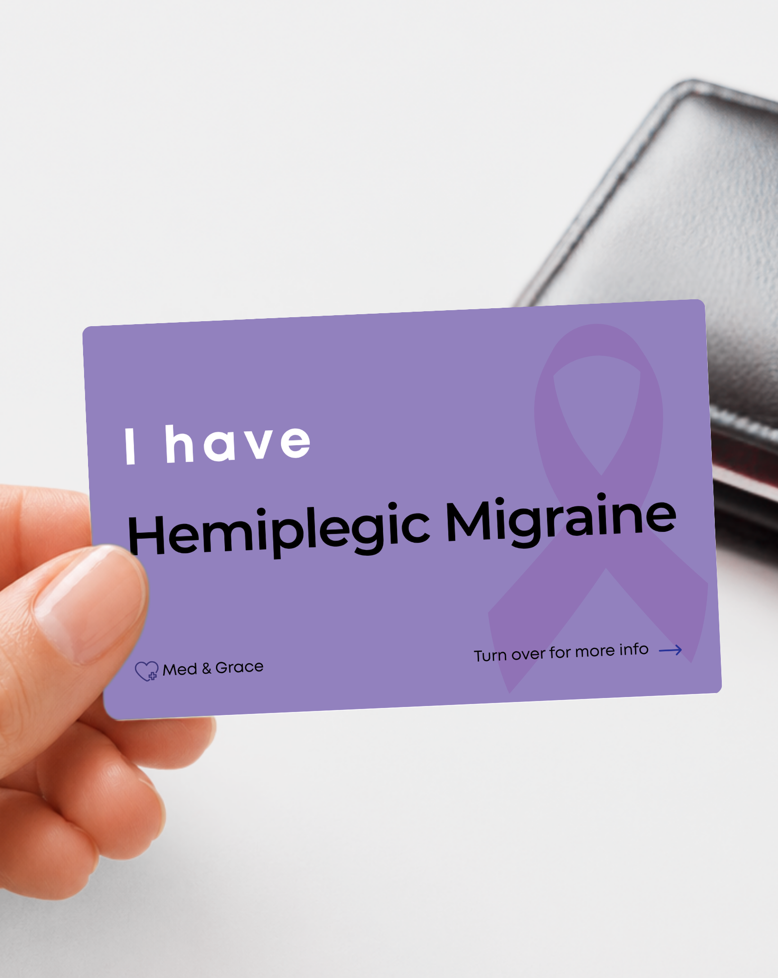 Purple Hemiplegic Migraines medical alert card held in hand