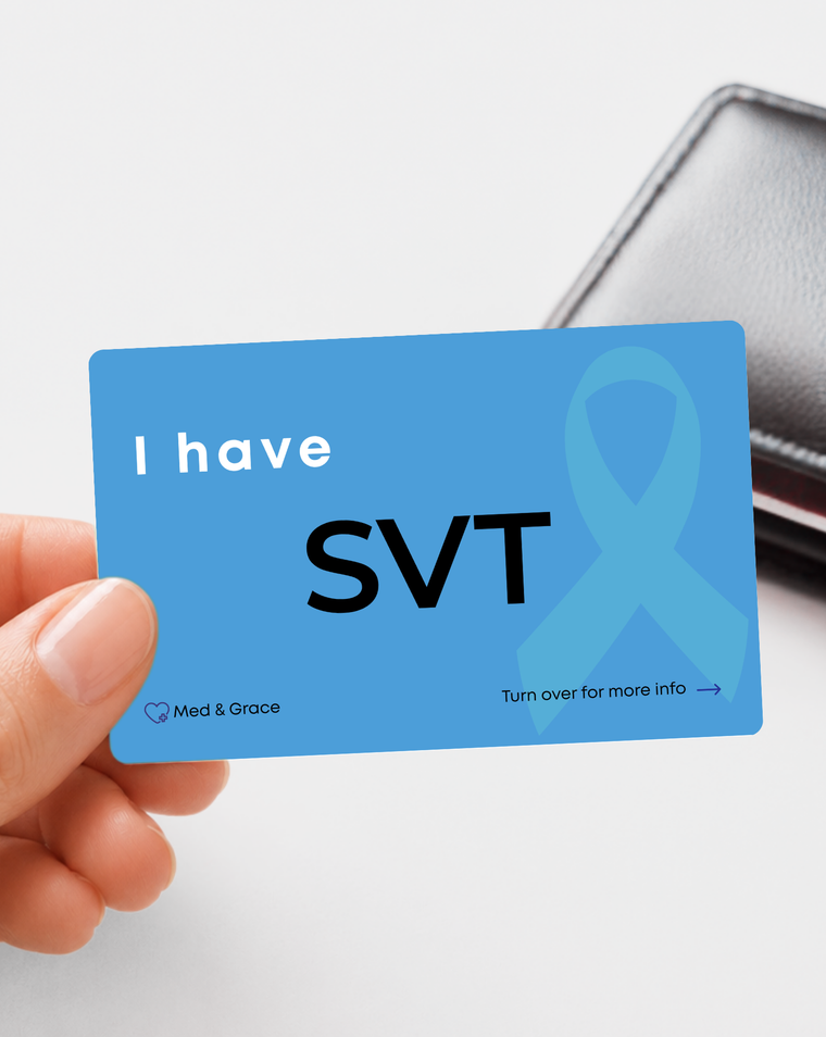 Blue SVT (Supraventricular Tachycardia) medical alert card held in hand
