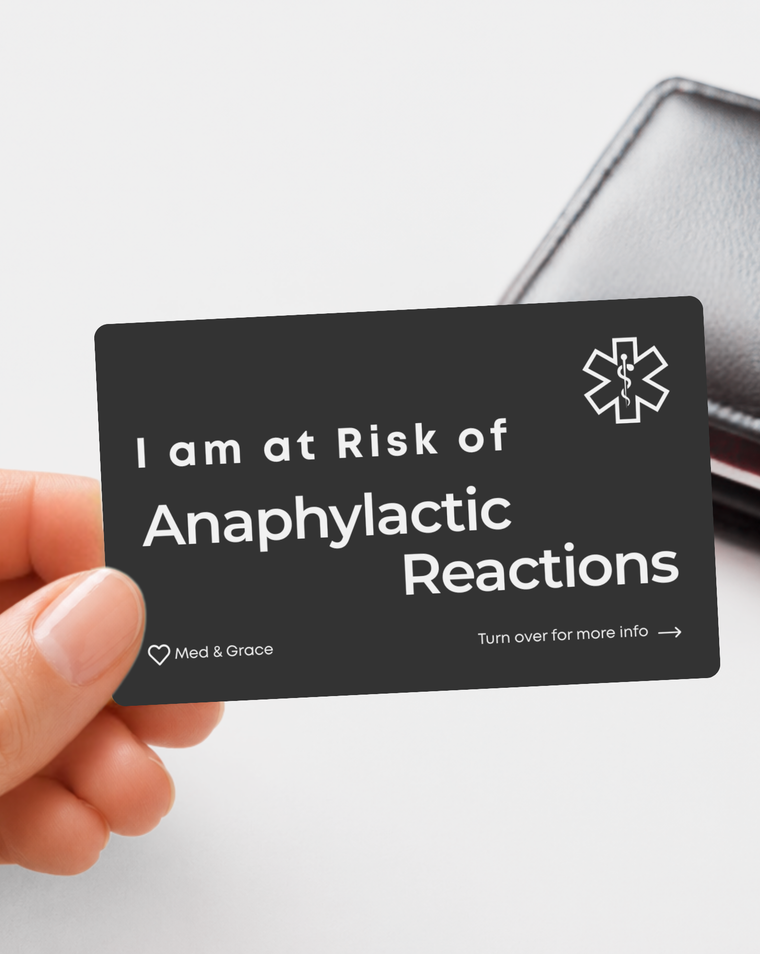 Black Anaphylactic Reactions engraved medical alert card held in hand