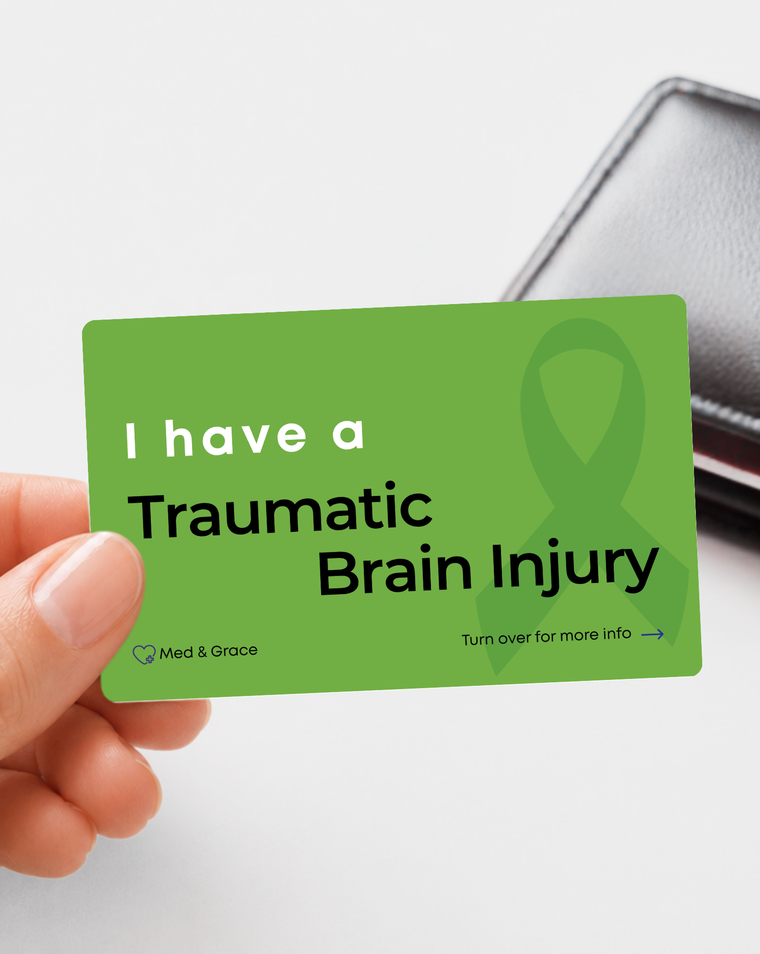Green Traumatic Brain Injury medical alert card held in hand