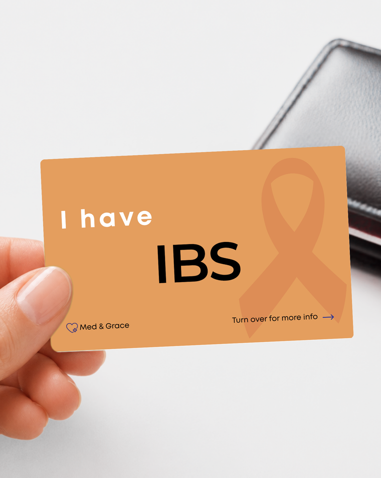 Orange IBS (Irritable Bowel Syndrome) medical alert card held in hand