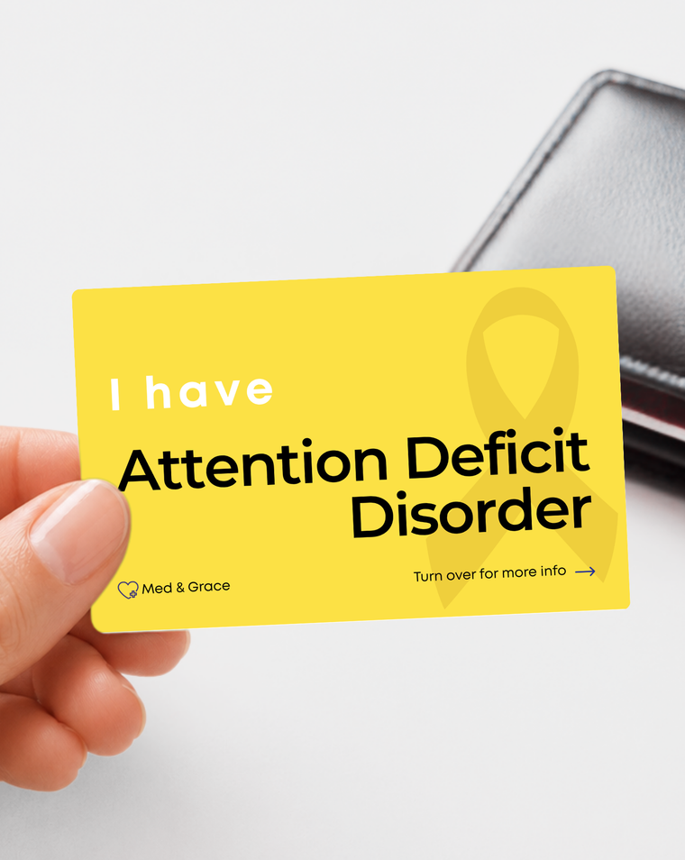 Yellow Attention Deficit Disorder medical alert card held in hand