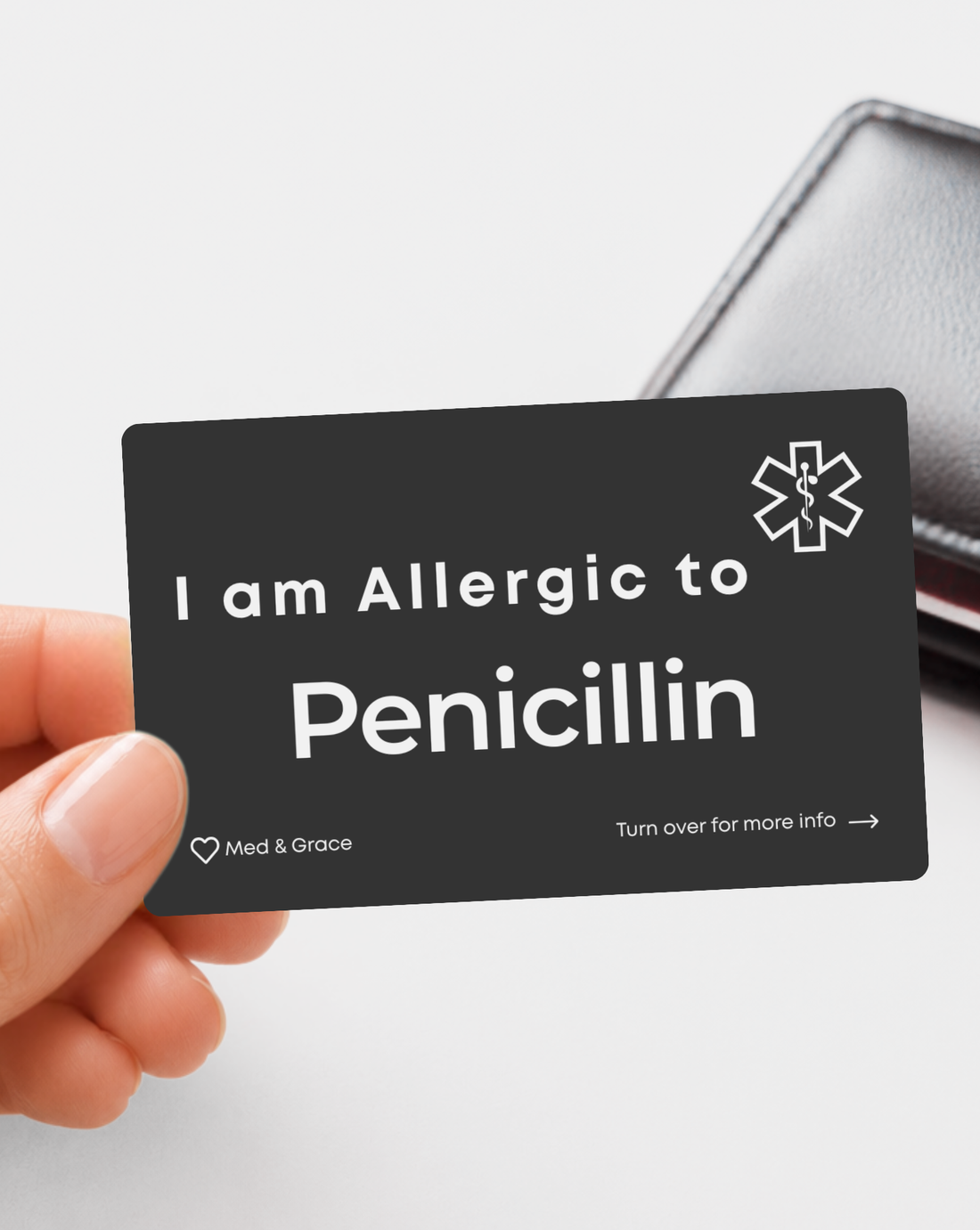 Black Penicillin Allergy engraved medical alert card held in hand