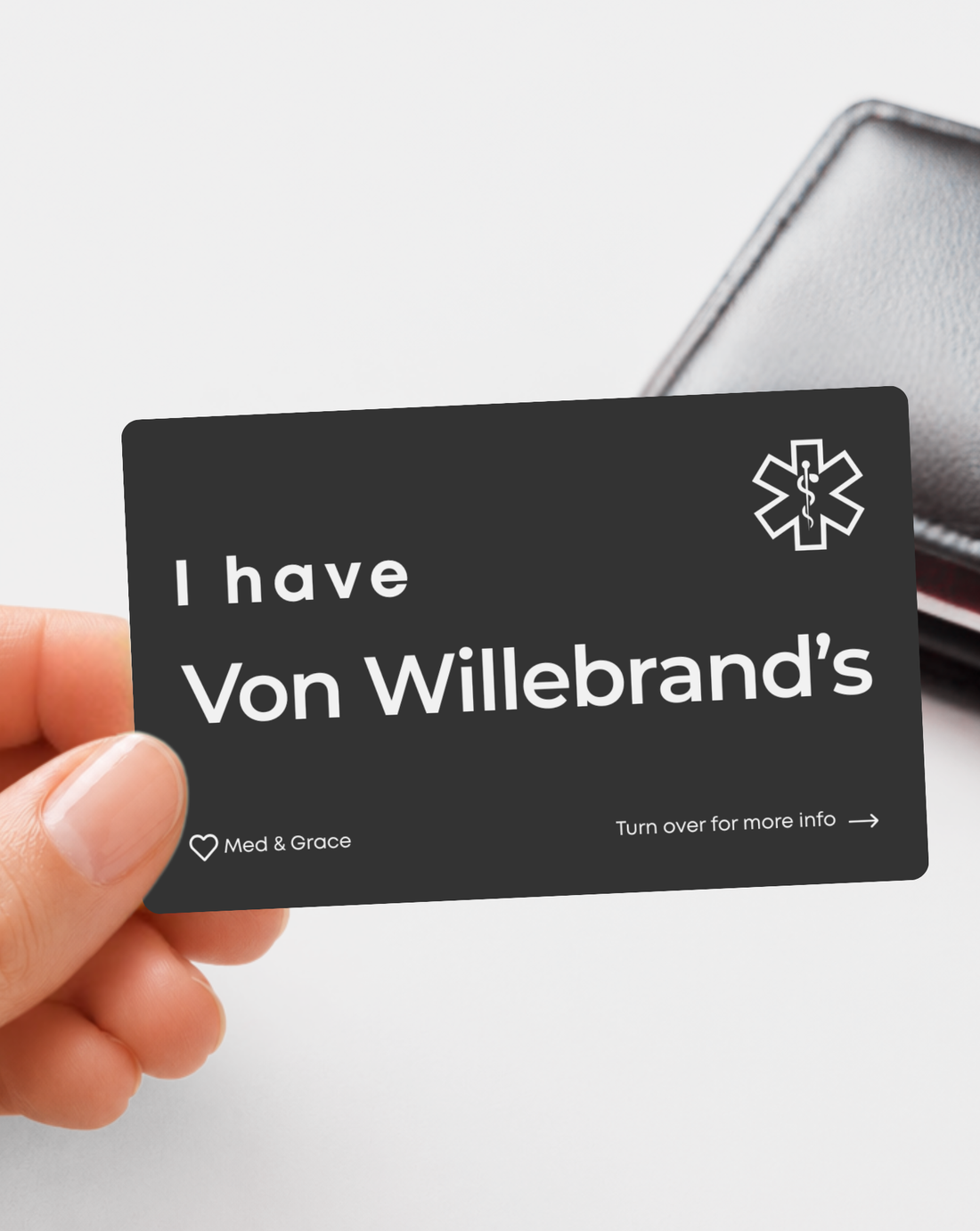 Black Von Willebrand Disease engraved medical alert card held in hand