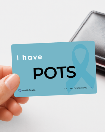 Teal POTS (Postural Orthostatic Tachycardia Syndrome) medical alert card held in hand