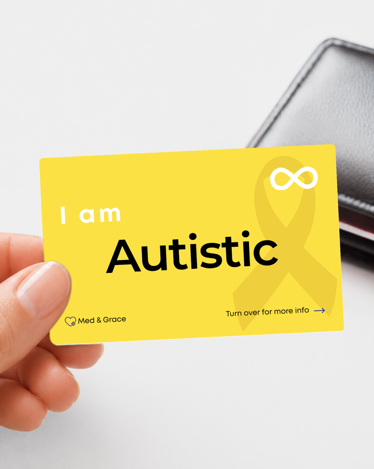 Yellow Autistic medical alert card held in hand