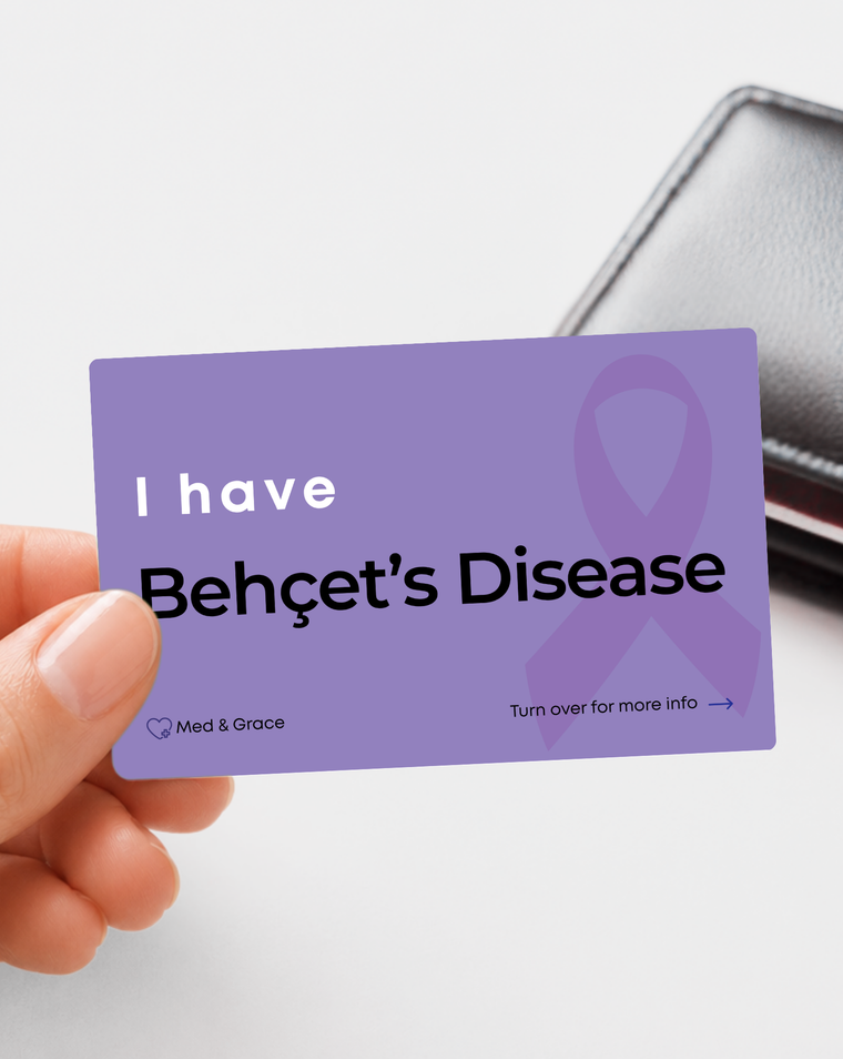 Purple Behçet’s Disease medical alert card held in hand