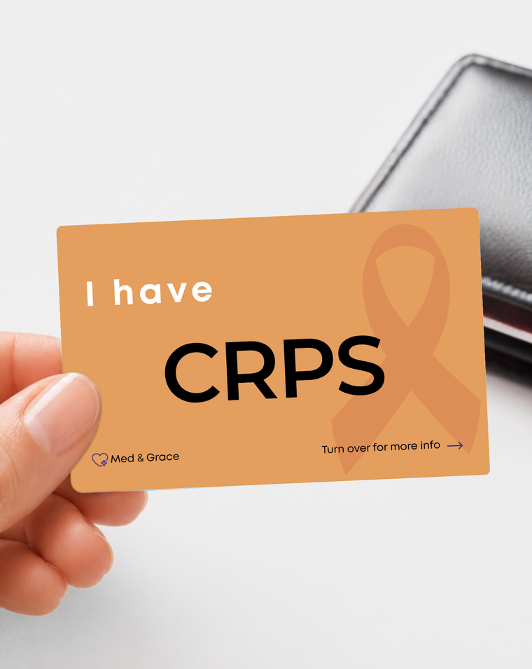 Orange CRPS - Complex Regional Pain Syndrome medical alert card held in hand