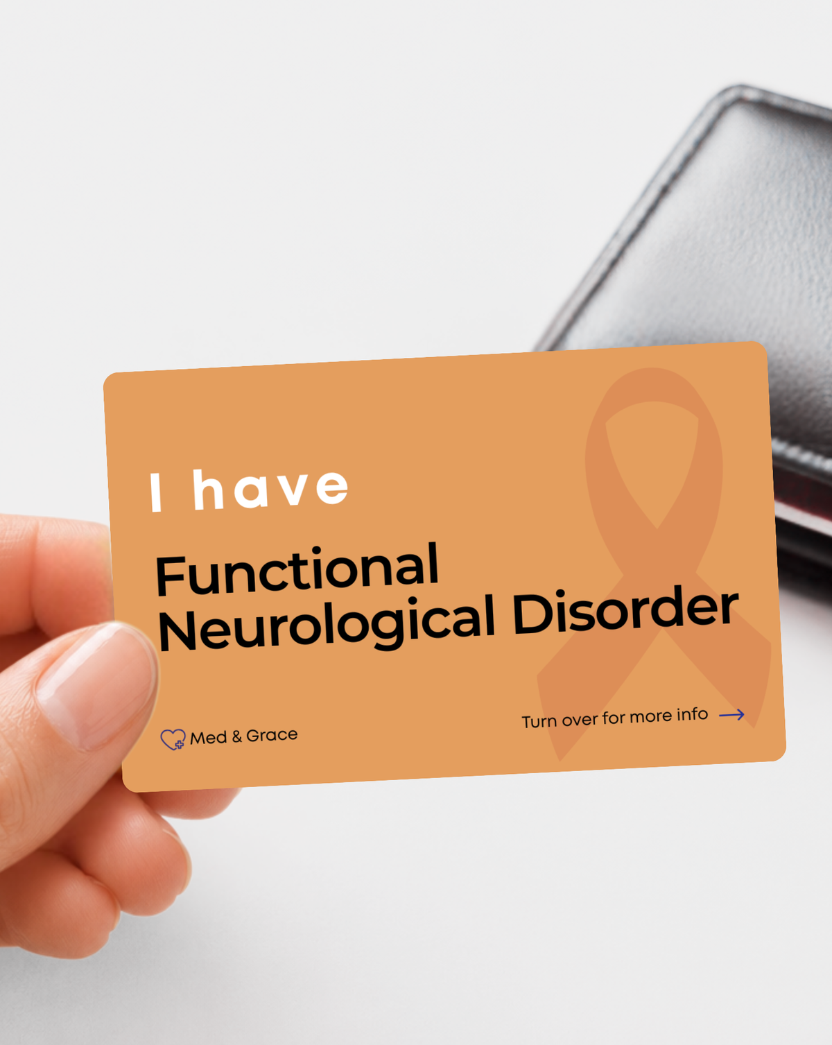 Orange Functional Neurological Disorder medical alert card held in hand