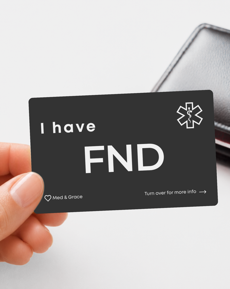 Black FND (Functional Neurological Disorder) engraved medical alert card held in hand